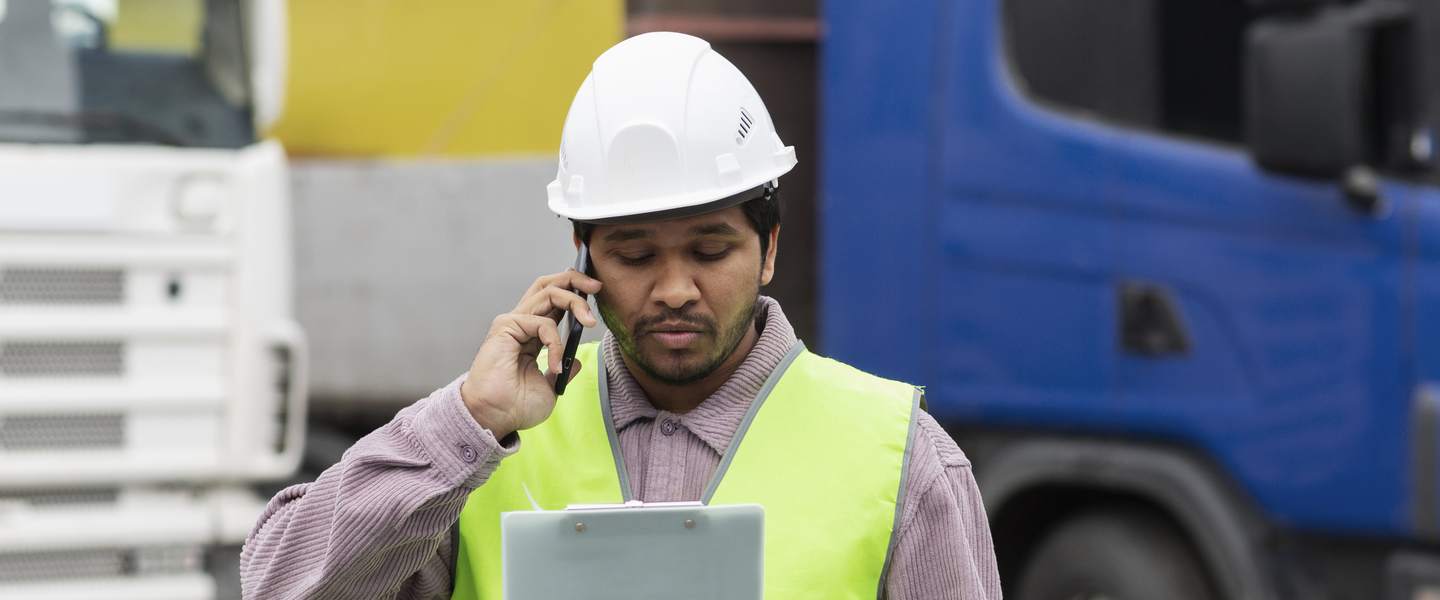 A business owner on the phone at a work site