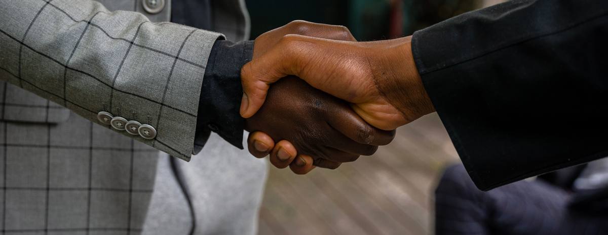 Two people shaking hands after an agreement