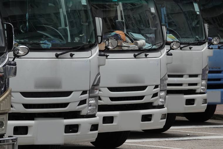 A line of haulage trucks parked at a depot